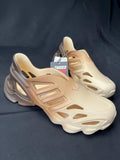 Beige sneakers with a visible brand tag on a dark background