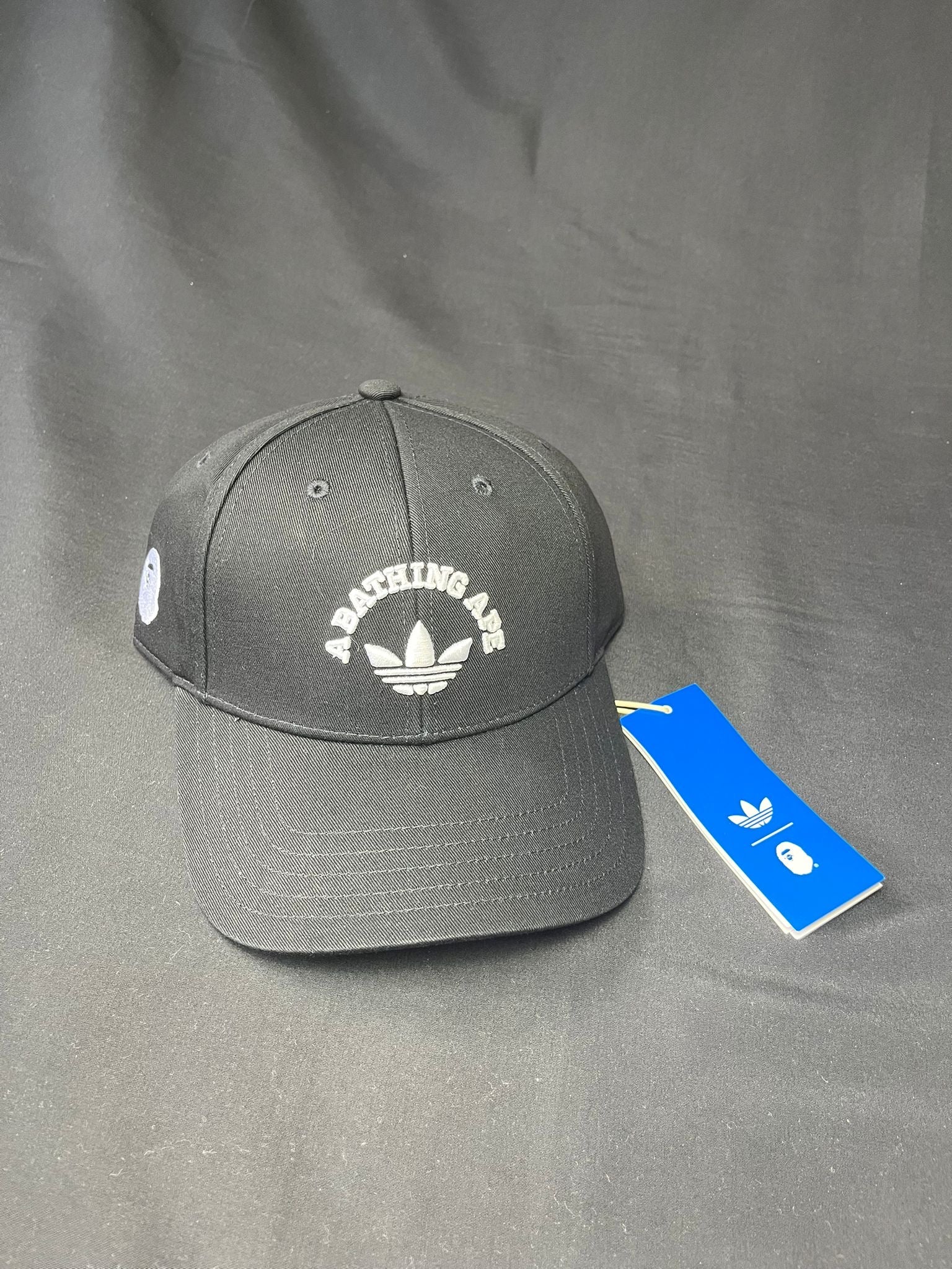 Adidas x BAPE black adjustable cap with embroidered Trefoil and A Bathing Ape branding, brand new with tags.