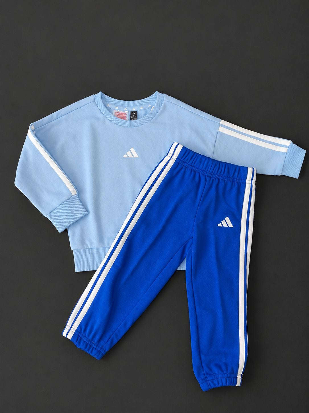 Boys adidas Light Blue and Royal Blue Tracksuit with crew neck sweatshirt and matching joggers, brand new with tags.