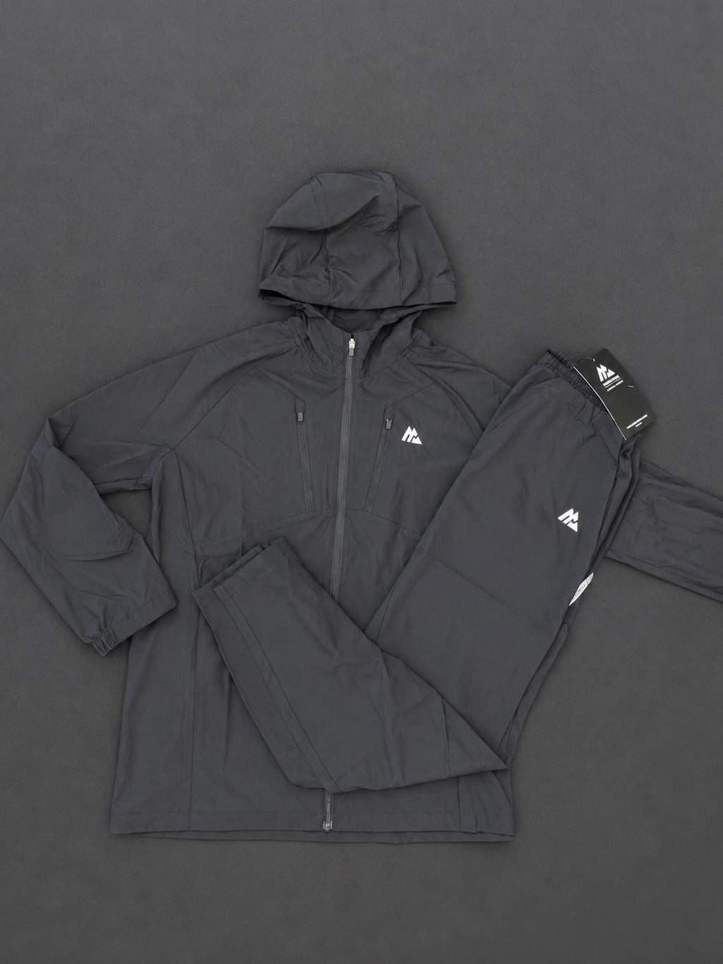Authentic Boys Montirex black tracksuit, brand new with tags, including a hooded jacket and matching trousers.