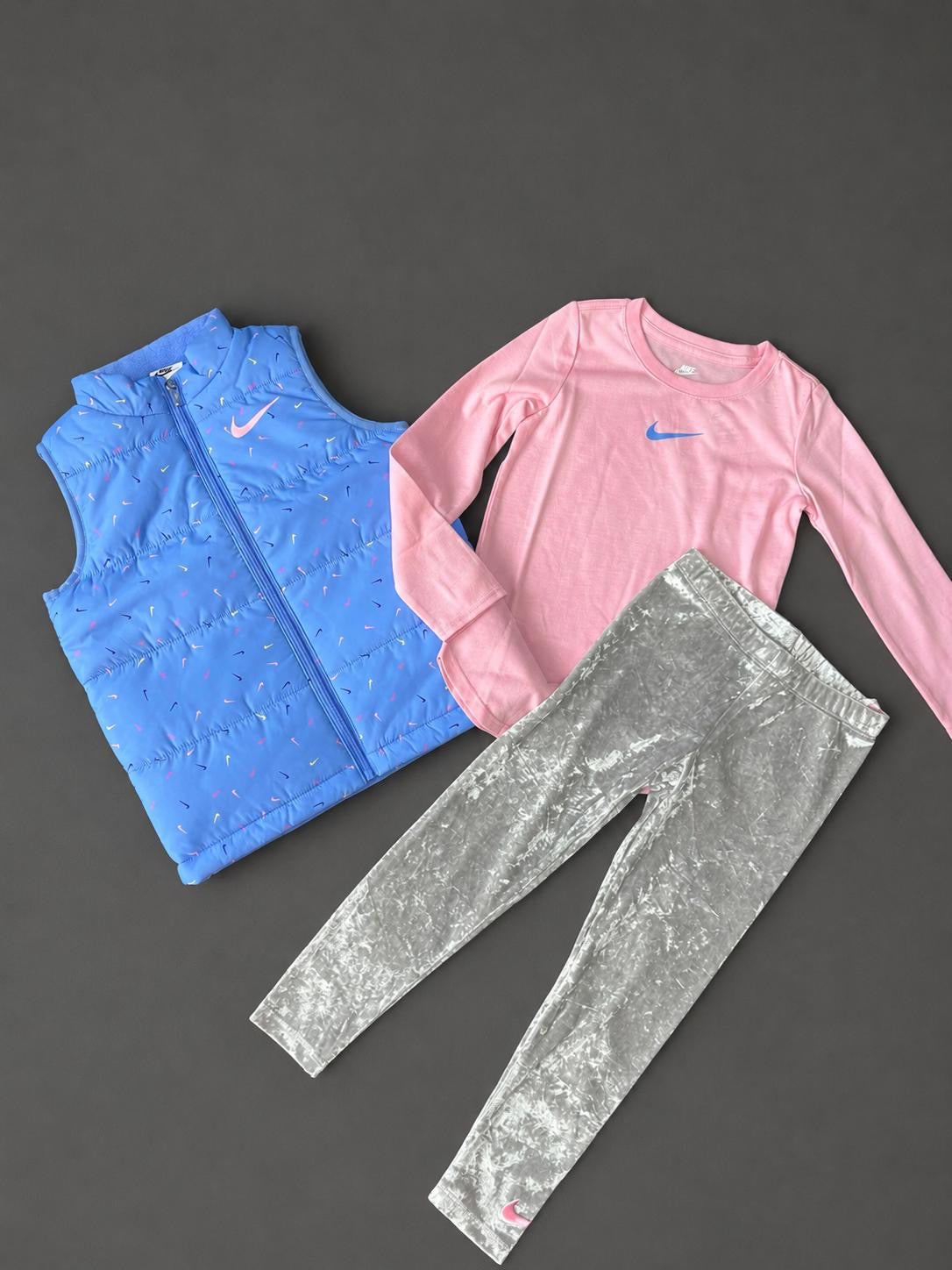 Girls Nike blue 3 piece set with padded gilet, pink long sleeve T-shirt and grey leggings, brand new with tags.