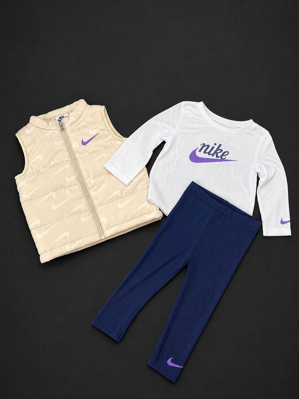Girls Nike cream 3 piece set with padded gilet, long sleeve T-shirt and navy ribbed leggings, brand new with tags.