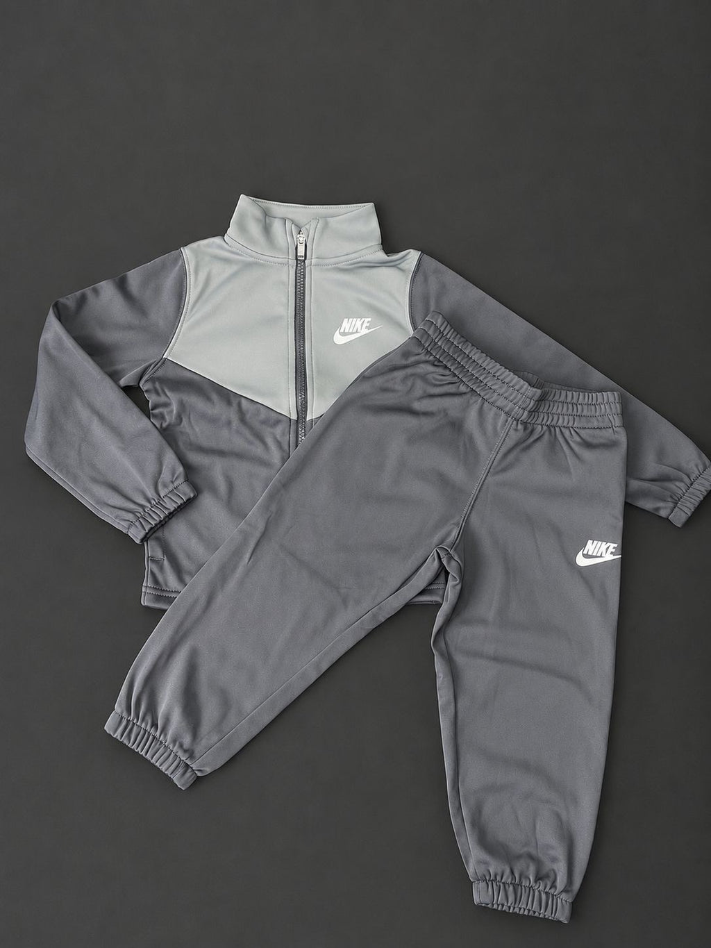 Kids Nike Grey Tracksuit with full zip jacket and matching cuffed joggers, brand new with tags.