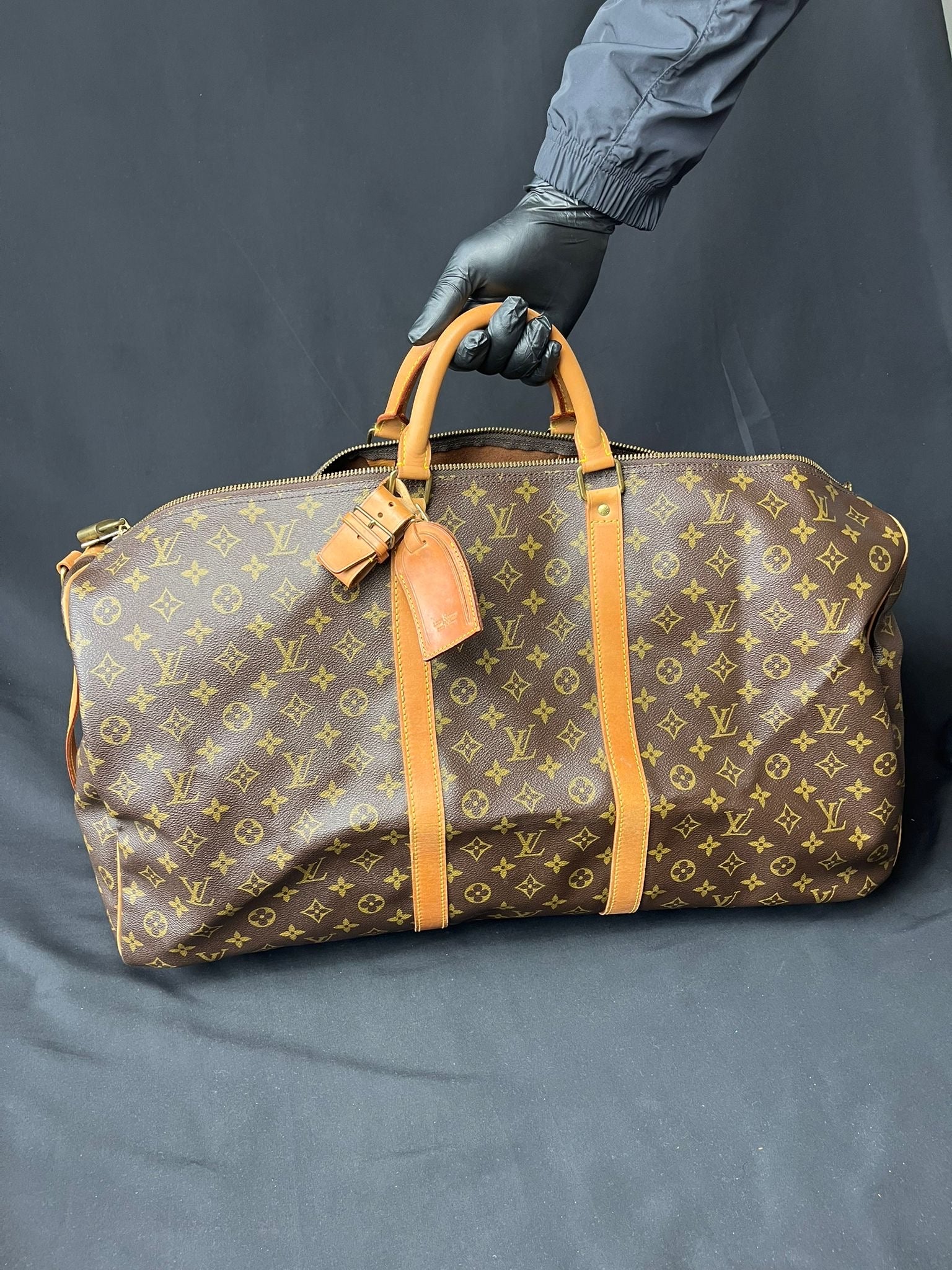 Authentic Louis Vuitton Keepall 60 Monogram travel bag, pre-owned in excellent condition with age-related marks.