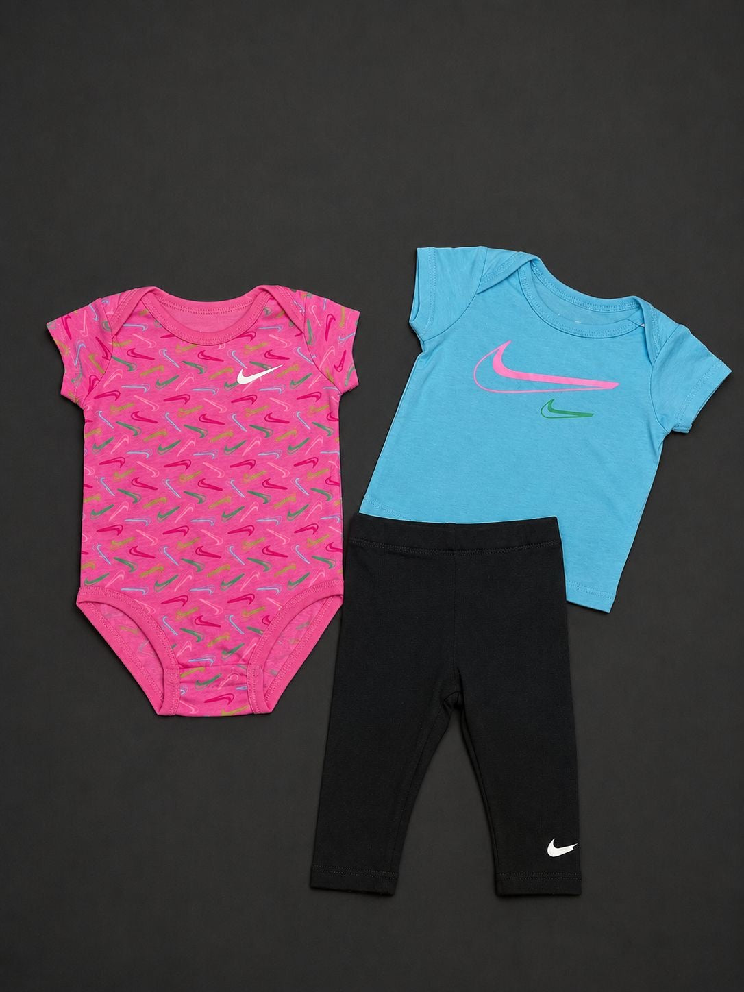 Nike baby 3 piece set with pink babygrow, blue Nike T-shirt and black leggings, brand new with tags.