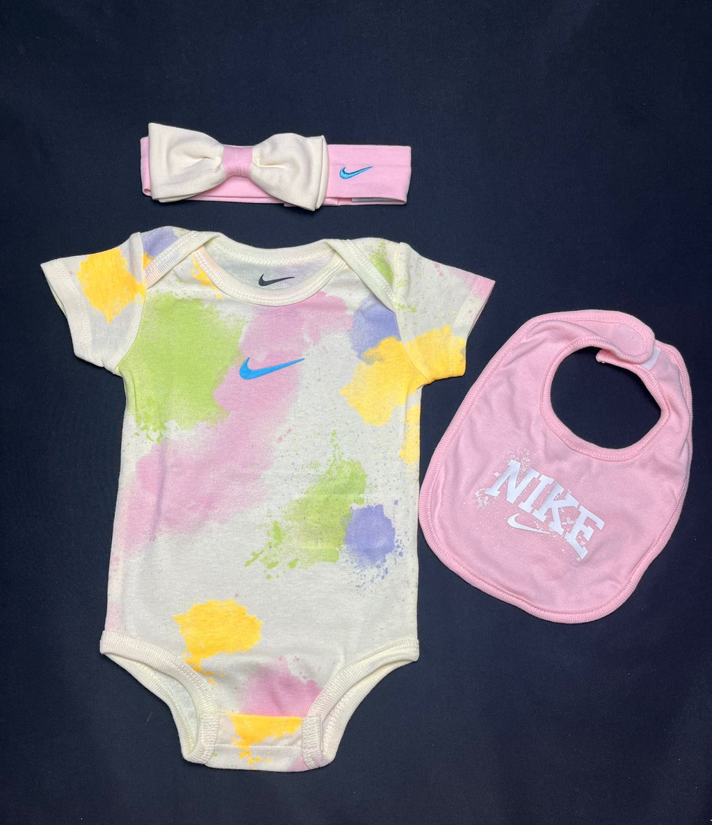 Nike baby 3 piece paint splash gift set with colourful babygrow, matching pink bib and bow headband, brand new in the box.