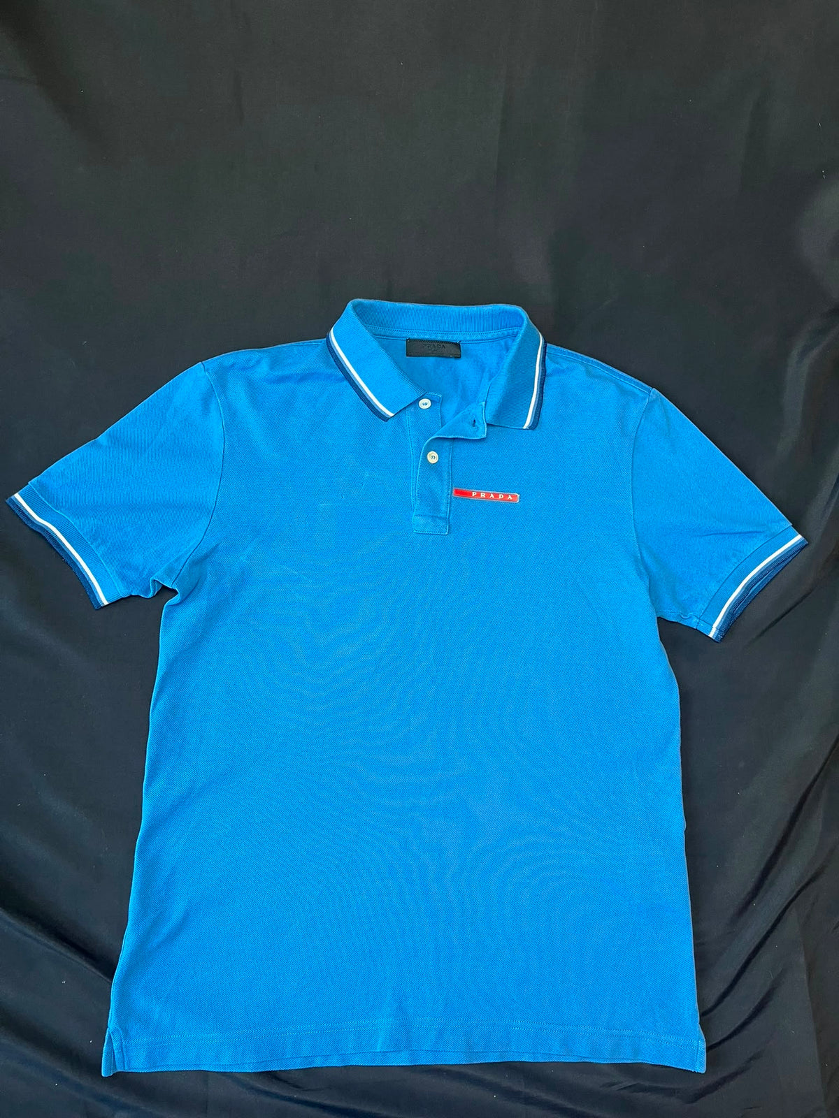 Authentic Prada blue polo shirt, pre-owned, slim fit with chest logo detail.