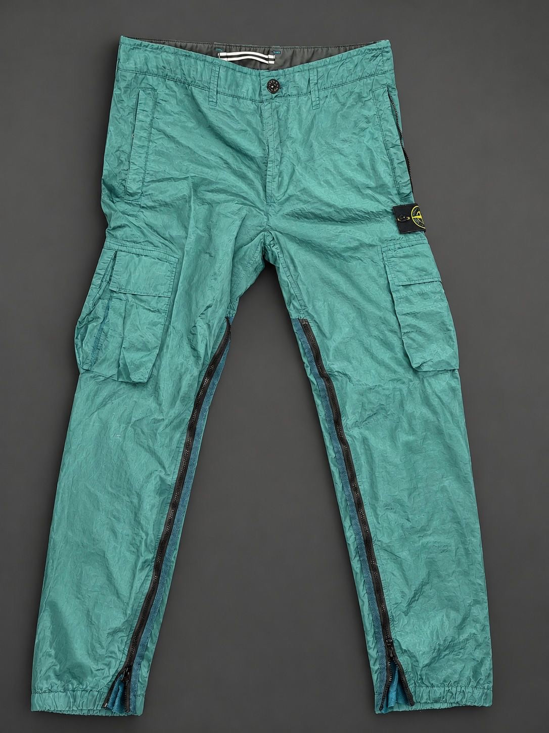 Authentic Stone Island Nylon Metal Turquoise cargo pants with removable Compass badge and full-length leg zips, brand new without tags.
