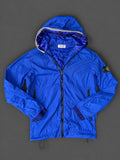 Authentic Stone Island Royal Blue hooded jacket with removable Compass badge, pre-owned in excellent condition.